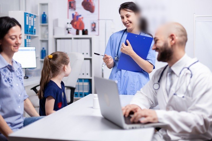 Clinicians talking with a mother and daughter