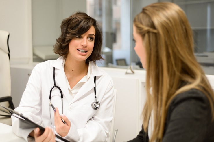 Clinician talking with a young woman